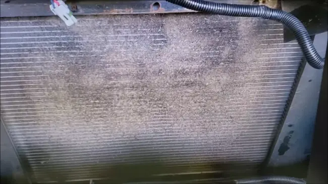 How do you clean behind a cast iron radiator on RVs