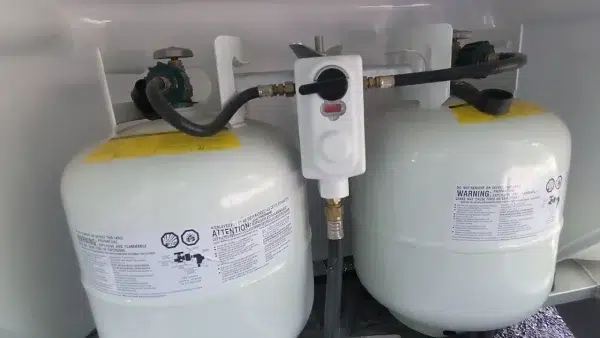 How can I check the propane tank pressure to determine the propane level