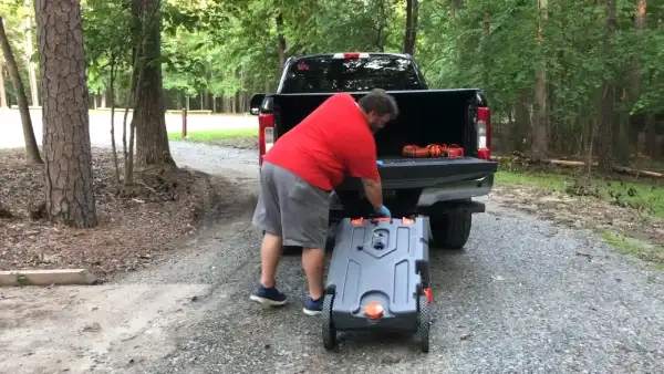 When Transporting a Portable Waste Tank, How Do You Empty it