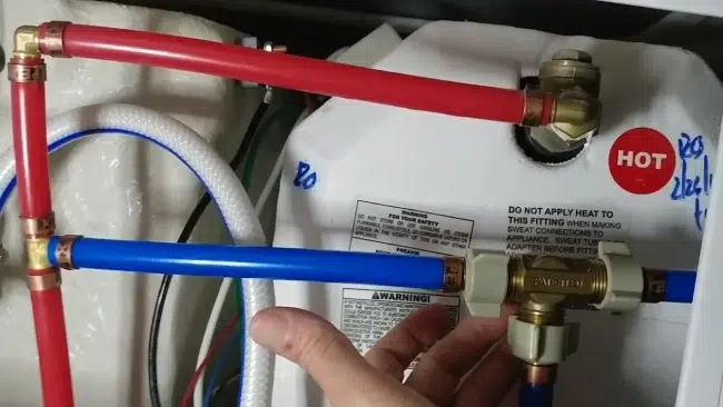 Where is the RV water heater bypass valve located